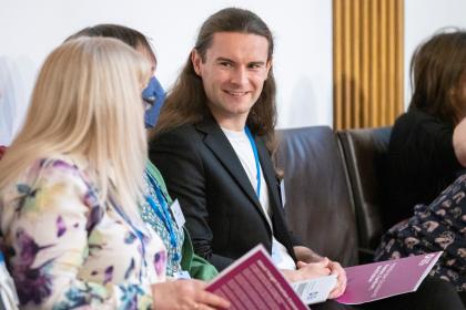 An image of Rob Hollis talking to someone at our Pathfinder event in Scottish Parliament
