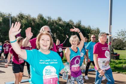 Sue taking part in the Walk Run in 2022 walking by the side of Target Ovarian Cancer CEO, Annwen Jones, both wearing charity t-shirts