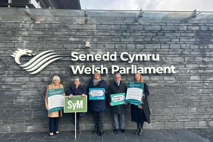 A group of Target Ovarian Cancer campaigners standing outside the Senedd