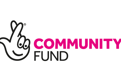 The National Lottery Community Fund logo - a white crossed fingers with a cartoon face with community fund written next to it