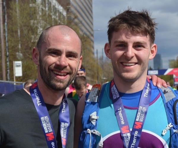 Two male Target Ovarian Cancer Supporters at the Manchester Marathon 2023.