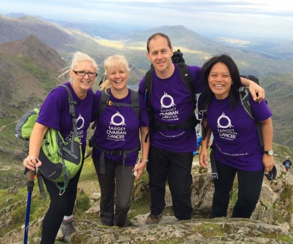 A group of supporters smiling at the top of Mount Snowdon 2023