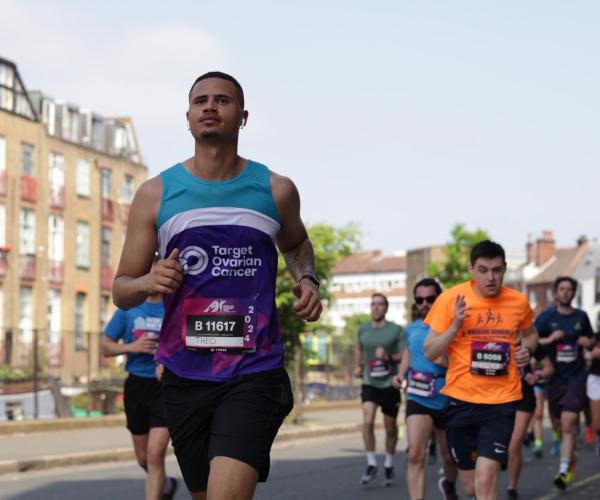 A male supporter running at the Hackney Half Marathon 2024