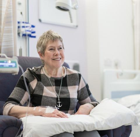 A woman in a checkered jumper having chemotherapy