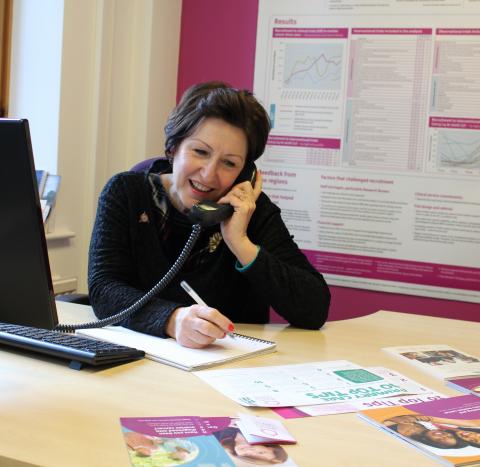 Target Ovarian Cancer Nurse Adviser, Val Lang, smiling while taking a call on our support line