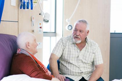 A woman talks to her husband whilst having chemotherapy