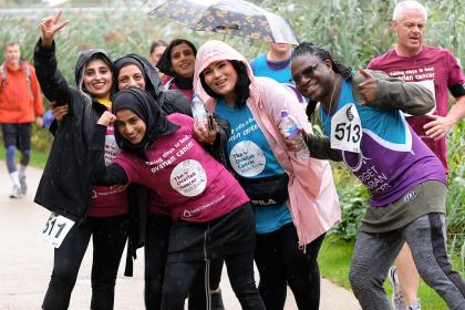 A group of fundraisers taking part in the Ovarian Cancer Walk|Run, smiling and laughing at the camera.jpg