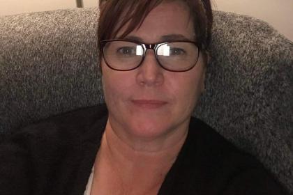 A selfie of sitting on the sofa smiling