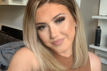 A selfie of summer in a brown top smiling to the camera