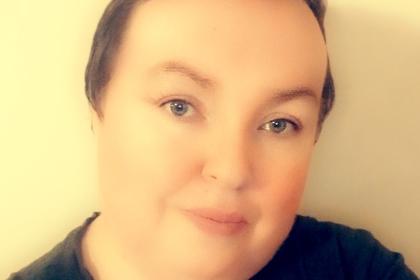 A selfie of Grainne wearing a black top with short hair