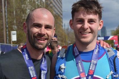 Two male Target Ovarian Cancer Supporters at the Manchester Marathon 2023.