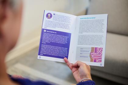Woman holding and reading information guide