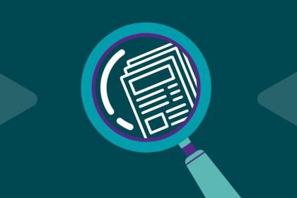 A graphic of a magnifying glass looking at a paper