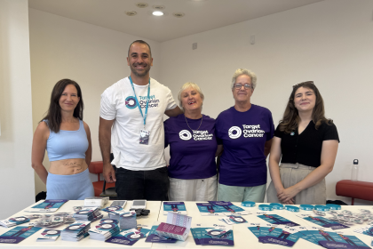 A photo of people in Target Ovarian Cancer t-shirts with awareness materials on a table
