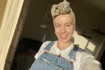 A photo of Claire wearing a headscarf smiling