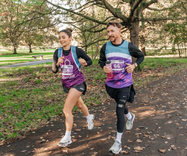 Photo of a man and woman running at the Target Ovarian Cancer London Walk|Run 2023