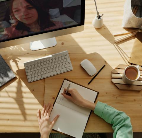 Computer on desk with notebook and keyboard and mouse