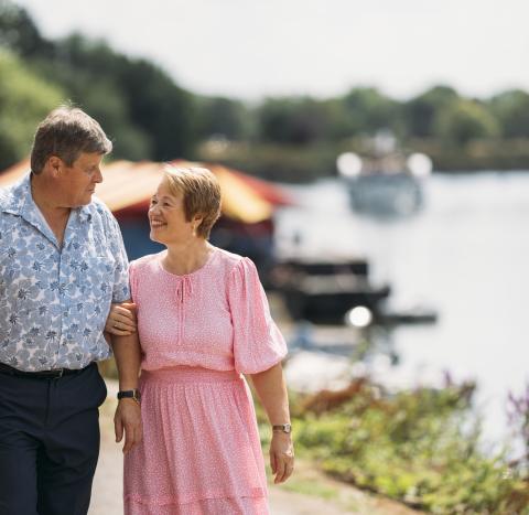 Couple linking arms and walking