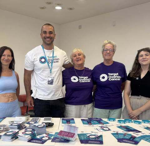 A photo of people in Target Ovarian Cancer t-shirts with awareness materials on a table