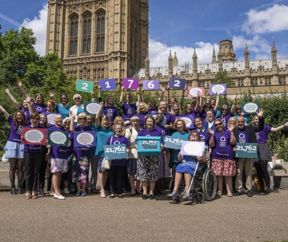 A group of Target Ovarian Cancer campaigners standing outside the House of Lords, Westminster