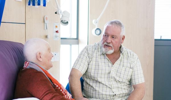 A woman talks to her husband whilst having chemotherapy