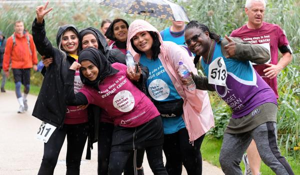 A group of fundraisers taking part in the Ovarian Cancer Walk|Run, smiling and laughing at the camera.jpg