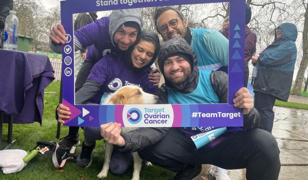 An image of four friends smiling with their dog inside a Target Ovarian Cancer branded frame