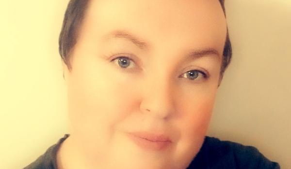 A selfie of Grainne wearing a black top with short hair