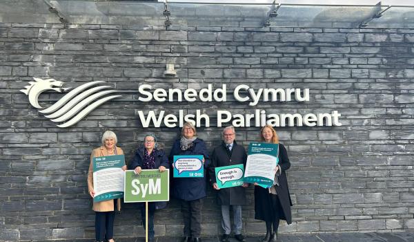 A group of Target Ovarian Cancer campaigners standing outside the Senedd