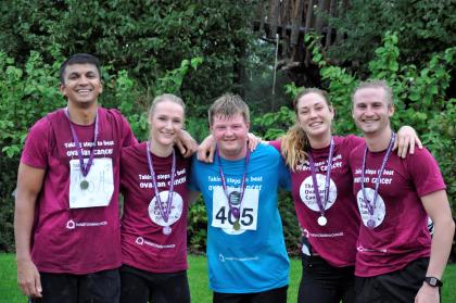 Five fundraisers at the Ovarian Cancer Walk|Run wearing medals and smiling