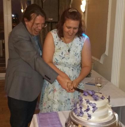 Megan and her husband Matt cutting their wedding cake