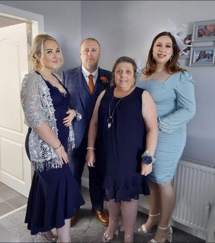 A family photo of Caitlin, Kacey, George and Carol McKean all dressed up smartly for an event