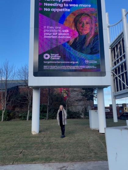 Natalie outside Target Ovarian Cancer awareness billboard by Meadowhall shopping centre