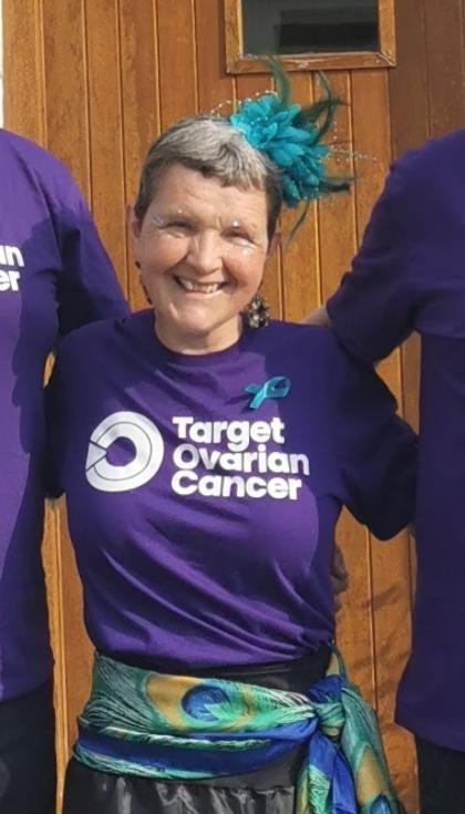 Jenny wearing a Target Ovarian Cancer purple tshirt with a blue flower in her hair at our Ovar-Dressed Belfast event in 2024