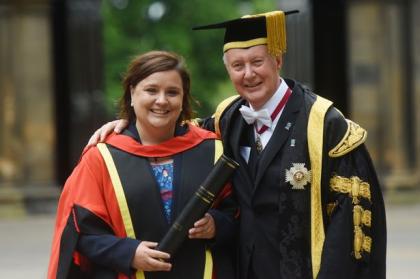 A photo of Susan and Kenneth Calman wearing university robes smiling