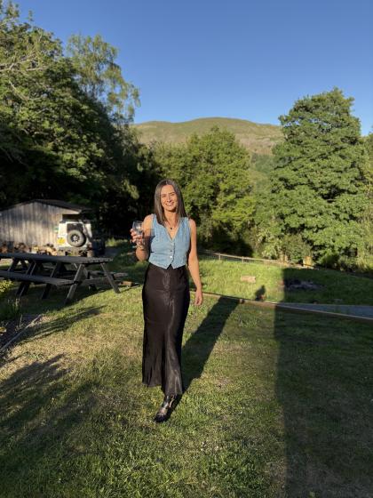 Lucy standing in a sunny garden smiling