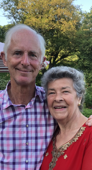 Georgina and her husband standing together both smiling