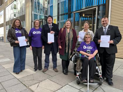 Campaigners and MPs pose outside the Department of Health in London in November 2024, to mark the formal handing-in of the letter to the Health Minister in England.